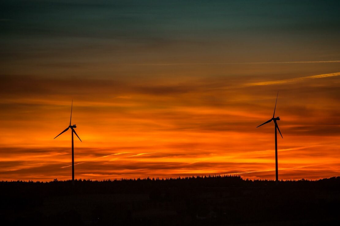 Wind turbines in the countryside at sunset.